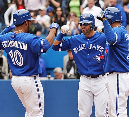 Edwin Encarnacion gets a hero's welcome at the plate after his three-run homer puts away the Rangers.  (US Presswire)