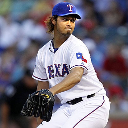 The Rangers' Yu Darvish withstands a two-hour rain delay to strike out seven in 5 1/3 innings and earn the win.  (Getty Images)