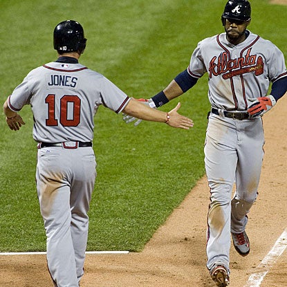 Jason Heyward (right) is greeted by Chipper Jones after hitting the two-run home run in the 12th inning. (US Presswire)