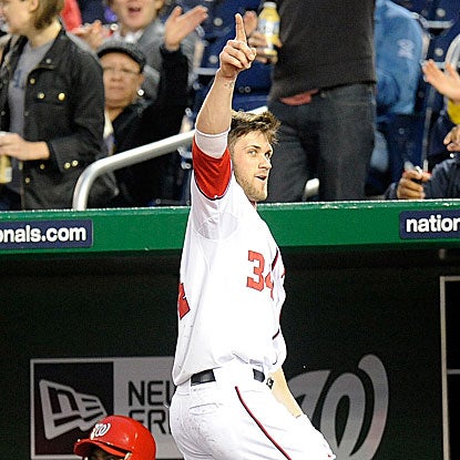 The Nats' 19-year-old phenom Bryce Harper salutes the home crowd after hitting his first career MLB home run.  (Getty Images)