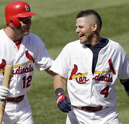 Lance Berkman congratulates Yadier Molina, who knocks in the winning run in the bottom of the ninth. (AP)
