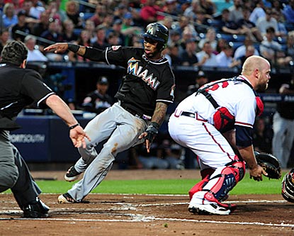 Jose Reyes slides past Brian McCann on a double steal in the fifth inning. It's Reyes' first career steal of home plate.  (Getty Images)