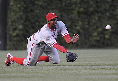 Juan Pierre helps out Roy Halladay with a diving catch that ends the first inning and saves a run.  (Getty Images)