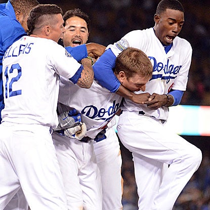 A.J. Ellis' bases-loaded walk in the ninth inning forces home the game-winning run for the Dodgers.  (Getty Images)