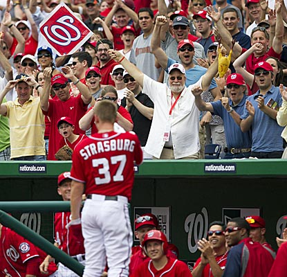 Almost embarrassed, Stephen Strasburg gets some love after hitting his first big-league homer.  (AP)