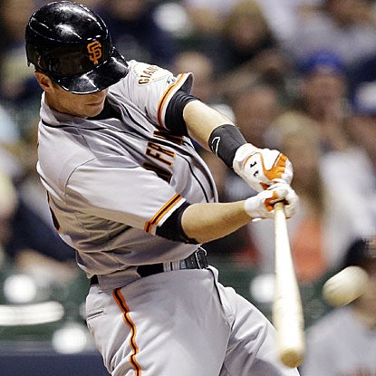 Buster Posey launches a HR off the Miller Park scoreboard and knocks in three runs in the Giants' win over the Brewers.  (AP)