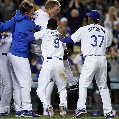 Teammates celebrate with A.J. Ellis (jumping) who propels Los Angeles to the win with a three-run homer. (Getty Images)