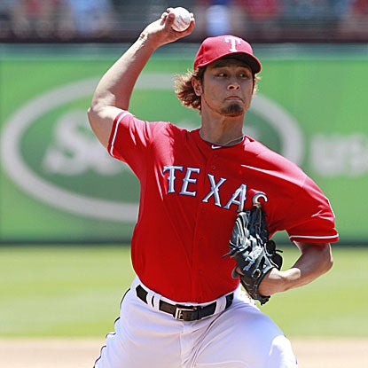 Yu Darvish surrenders three runs on seven hits in five innings of work but earns the win to improve to 7-2 for the Rangers.  (US Presswire)