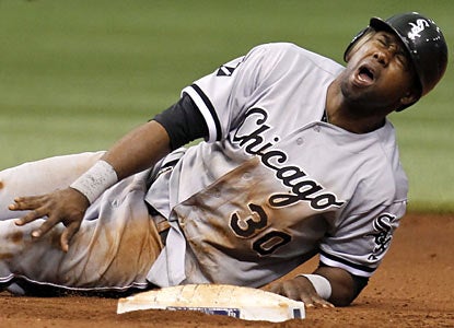 Alejandro De Aza leaves in the sixth inning after getting hit by a ball near the knee on a pick-off attempt. (AP)