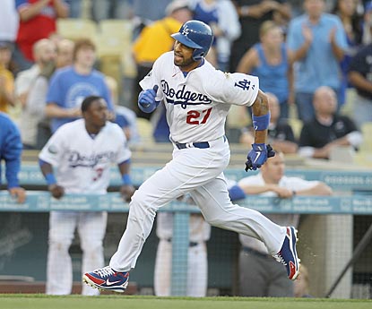 Matt Kemp hustles to score from first base in the first inning, but aggravates his tender hamstring in the process.  (Getty Images)