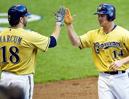 Brooks Conrad, who ends his 0-for-27 slump, celebrates his homer with Shawn Marcum. (US Presswire)