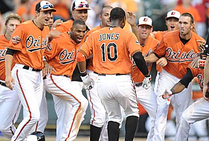 Adam Jones, who enters in an 0-for-18 slump, hits the game winner to give the O's their eighth straight extra-inning win. (Getty Images)