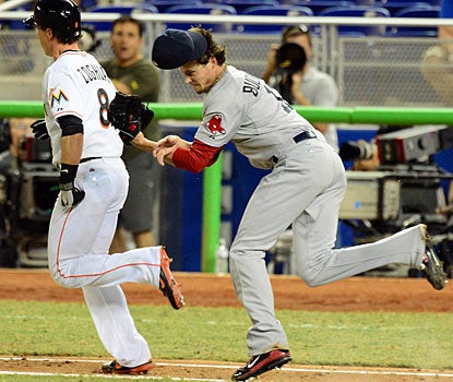 Clay Buchholz helps his team more ways than just on the mound as he tags out Chris Coghlan. (US Presswire)
