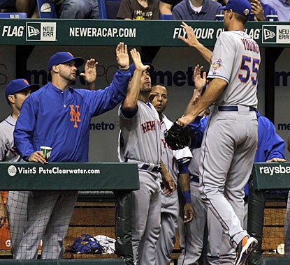 Chris Young is cheered by his teammates after throwing 106 pitches to earn his first win since April 5, 2011. (AP)