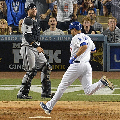 James Loney scores what turns out to be the Dodgers' winning run on a wild pitch in the eighth inning.  (AP)
