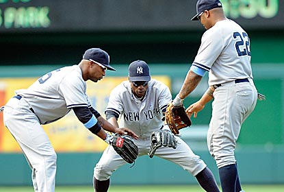 The New York outfield comes together in celebration of the Yanks' victory over the Nationals -- their ninth straight.  (Getty Images)