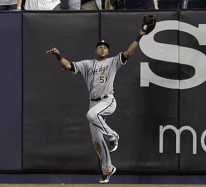 Chicago right fielder Alex Rios hangs on to make a leaping catch of Derek Jeter's deep fly for the final out. (AP)