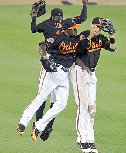 Xavier Avery, Adam Jones and Ryan Flaherty celebrate after the Orioles beat the Indians in Baltimore. (Getty Images)