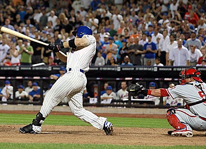 David Wright connects for a single with two outs in the bottom of the ninth for the Mets. (Getty Images)