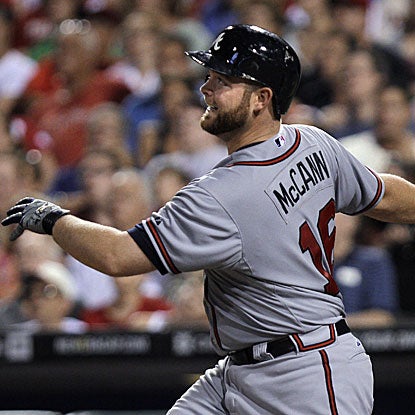 Brian McCann's eighth-inning grand slam breaks open the game for the Braves, as they go on to defeat the Phillies.  (AP)