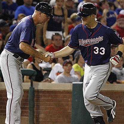 Justin Morneau homers and collects an RBI single as the Twins knock off the Rangers.  (AP)