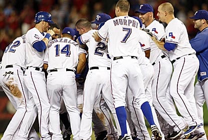 Somewhere in this mob is Ian Kinsler, whose single in the 13th gives the Rangers an unlikely win.  (US Presswire)