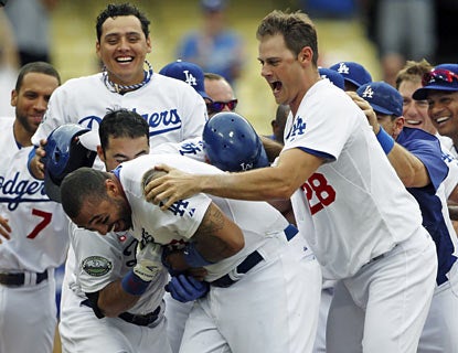 The Dodgers are ecstatic to have Matt Kemp back in the lineup. The slugger ends the game with a walk-off blast in the 12th. (AP)
