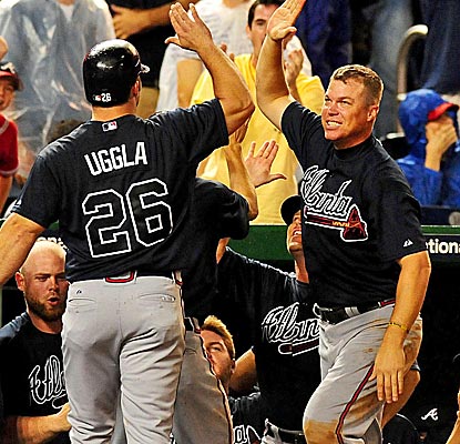 Chipper Jones congratulates Dan Uggla after Uggla scores the run that caps the Braves' huge comeback.  (US Presswire)