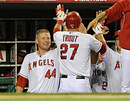 Mike Trout high-fives Mark Trumbo (left) in the dugout after hitting a solo home run in the seventh inning. (US Presswire)