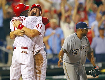John Mayberry (far left) and Erik Kratz celebrate Philly's victory while Francisco Rodriguez contemplates another blown save.  (Getty Images)
