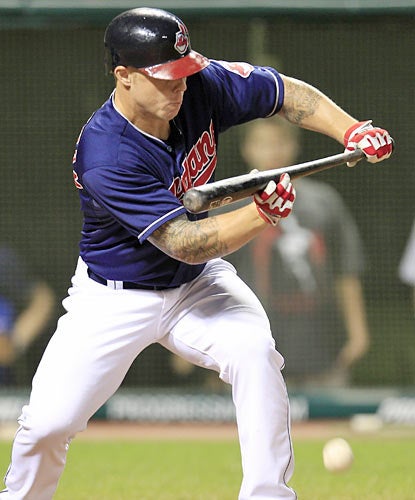 The Indians perform a suicide squeeze on this bunt by Aaron Cunningham to put them ahead in the seventh inning. (AP)