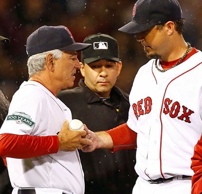 Josh Beckett retires the first eight batters, but gets into trouble before leaving with a back injury.  (Getty Images)