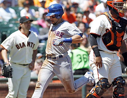 Mets center fielder Andres Torres scores in the fifth inning in between former Giants teammates Barry Zito and Hector Sanchez.  (AP)