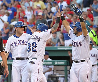 Texas batters celebrate early and often. Ian Kinsler, Josh Hamilton and Geovany Soto do so here in the second inning.  (US Presswire)