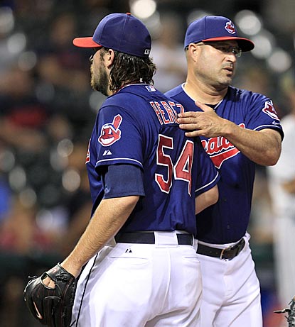 Indians manager Manny Acta tries to comfort closer Chris Perez after his second disastrous outing in a span of three days.  (AP)