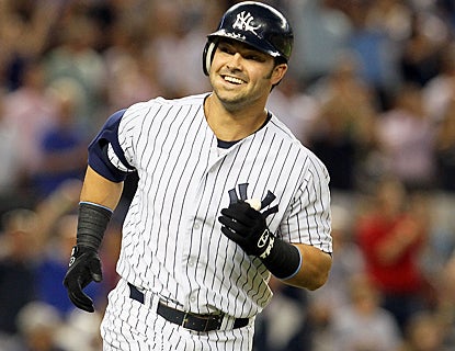 Nick Swisher smiles as he rounds the bases after hitting his grand slam in the third inning. (Getty Images)