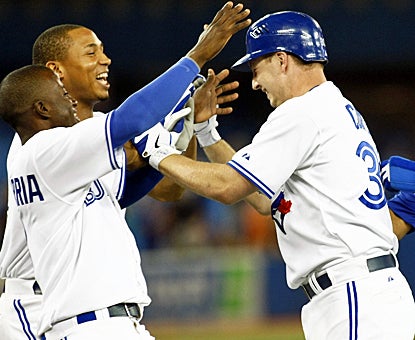 Teammates celebrate with David Cooper (late) after his game-winning single in the 11th inning against the White Sox. (US Presswire)