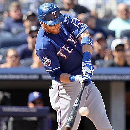 Craig Gentry delivers a two-run single in the seventh inning to put the Rangers past the Yankees. (Getty Images)