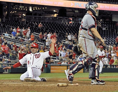 Danny Espinosa scores the winning run on an error in the 13th inning to give the Nationals a 5-4 win. (AP)
