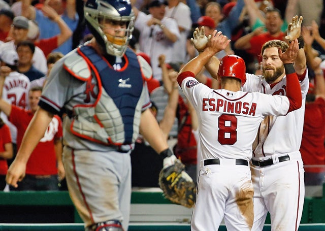 Washington's Danny Espinosa celebrates the winning run with teammate Jayson Werth. (AP)