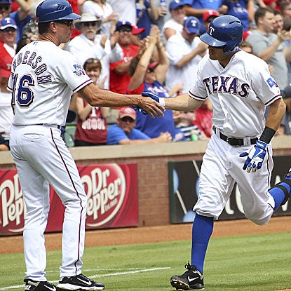 Ian Kinsler homers in the first inning and hits a three-run triple in the third to help stake the Rangers to an early 9-0 lead. (Getty Images)