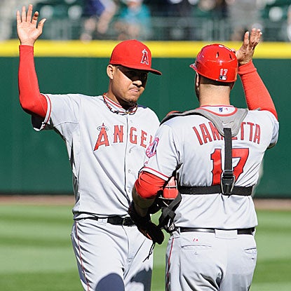 Reliever Ernesto Frieri and Chris Iannetta celebrate after the Angels saddle Felix Hernandez with his first loss since June 12. (US Presswire)