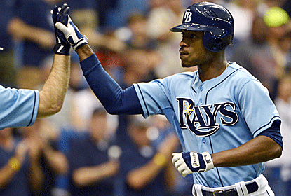 B.J. Upton is congratulated after hitting one of his three home runs Sunday -- just the third Ray to do so.  (AP)