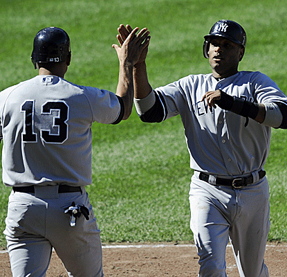Alex Rodriguez greets Robinson Cano at the plate after Cano homers in the Yankees' blowout win.  (AP)