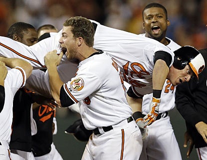 It's only fair the Orioles carry off Nate McLouth moments after he walks off against the Rays in the ninth. (AP)