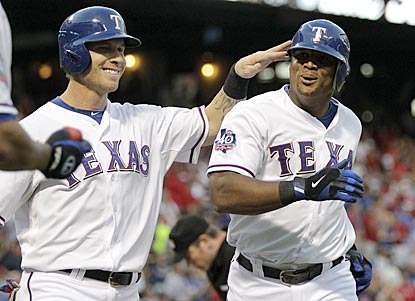 Josh Hamilton congratulates Adrian Beltre on his home run in the first inning, which pushes Texas' lead to 3-0.  (AP)