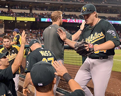 The A's congratulate A.J. Griffin, who exits after eight shutout innings. The rookie improves to 6-0 on his young career. (Getty Images)