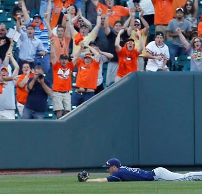 Matt Joyce can't quite make the play on Manny Machado's bloop single, to the delight of the Orioles faithful.  (Getty Images)