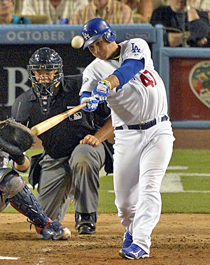 Luis Cruz hits a three-run home run during the sixth inning in the Dodgers' win against the Cardinals. (AP)