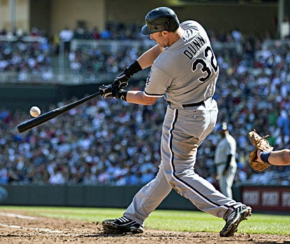 Adam Dunn hits a double in the seventh inning against the Twins at Target Field. (US Presswire)